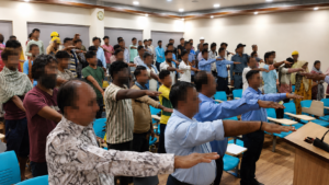 Workers taking the anti-tobacco pledge with hands raised at a Live Life Rehab awareness event
