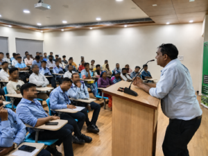 Speaker addressing factory staff at a Nasha Mukti Kendra Gujarat de-addiction awareness session